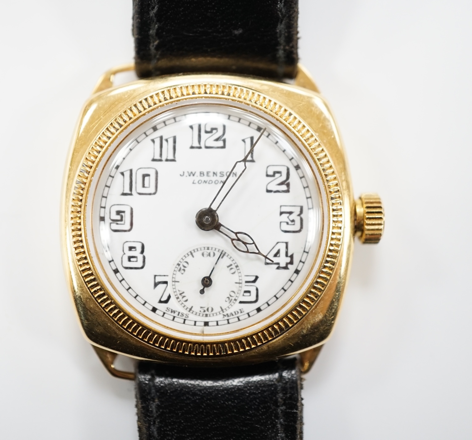 A gentleman's yellow metal J.W. Benson manual wrist watch, with Arabic dial and subsidiary seconds, on a black leather strap.